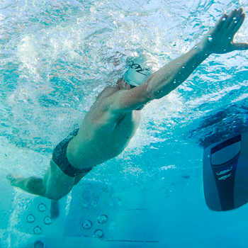 Man swimming in a swim spa.